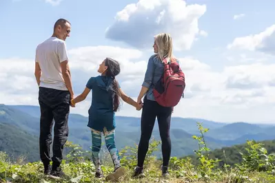 family holding hands at mountain overlooks