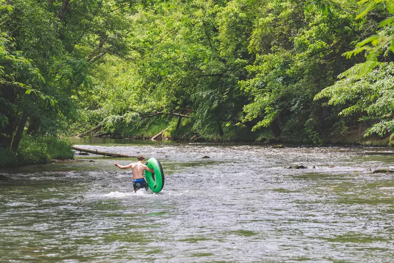 Person tubing on lake