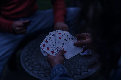 couple playing cards at night
